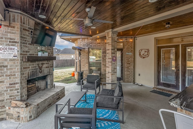 view of patio / terrace with an outdoor brick fireplace and ceiling fan