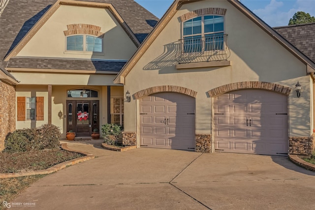 view of front of home featuring a balcony and a garage