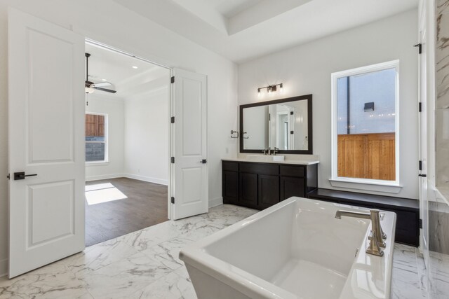 bathroom with a bathing tub, ceiling fan, and vanity