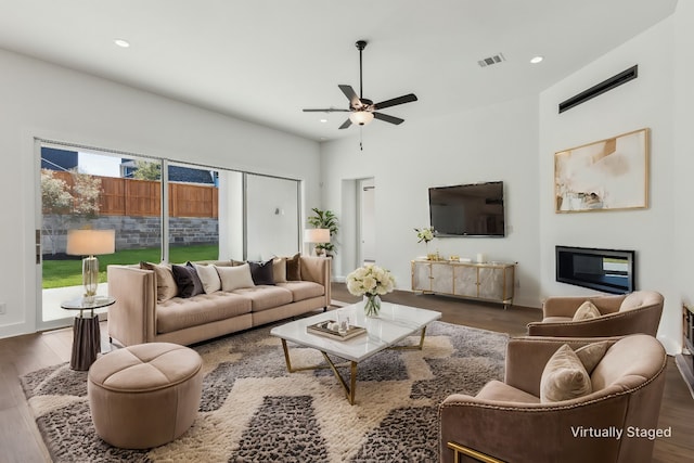 living room with dark hardwood / wood-style floors and ceiling fan