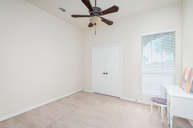 interior space with light colored carpet and ceiling fan