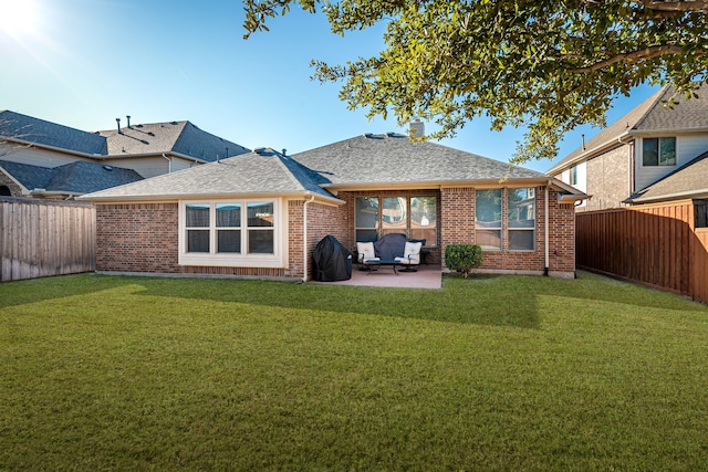 rear view of property featuring a lawn and a patio