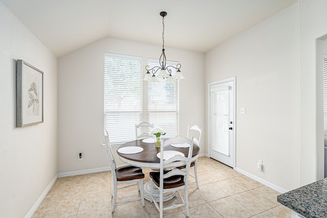 dining space with light tile patterned flooring, lofted ceiling, and an inviting chandelier