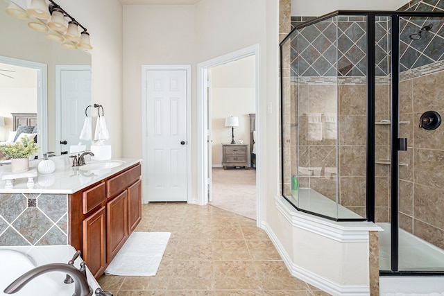 bathroom with tile patterned flooring, vanity, and walk in shower