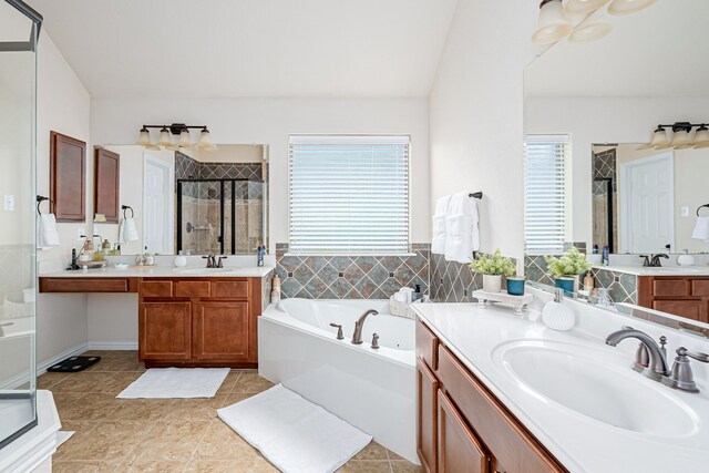 bathroom featuring vanity, tile patterned flooring, plus walk in shower, and a healthy amount of sunlight