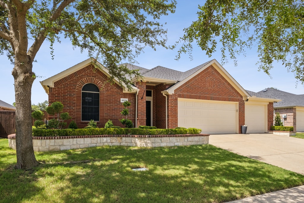 ranch-style home with a garage and a front yard