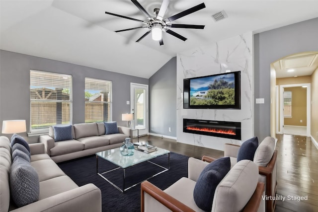 living room with a premium fireplace, ceiling fan, dark hardwood / wood-style floors, and lofted ceiling