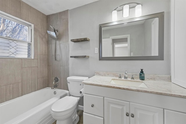 full bathroom featuring tiled shower / bath, vanity, and toilet