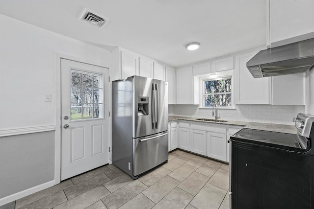 kitchen with sink, appliances with stainless steel finishes, white cabinets, decorative backsplash, and exhaust hood