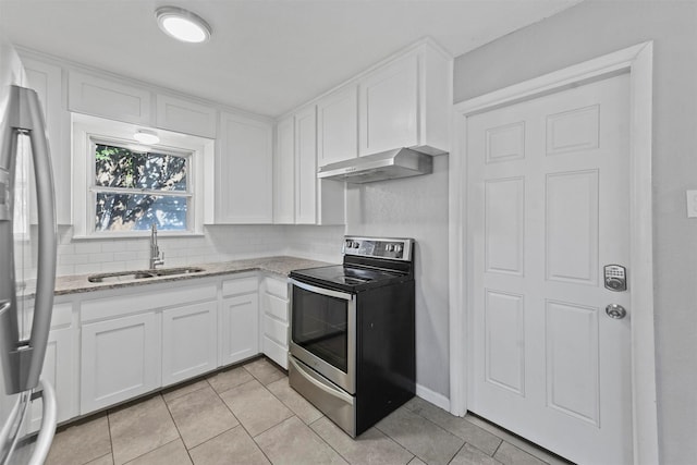 kitchen with sink, stainless steel appliances, tasteful backsplash, light stone countertops, and white cabinets