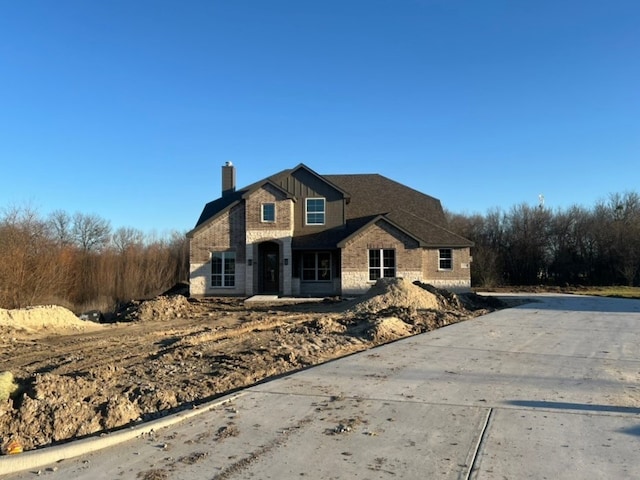 view of front of house featuring a chimney