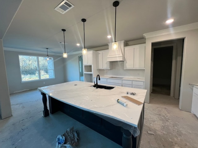 kitchen featuring a sink, visible vents, white cabinets, stovetop, and custom range hood