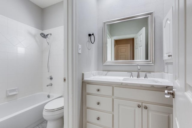 full bathroom featuring toilet, tiled shower / bath, and vanity