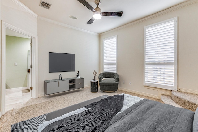 bedroom featuring ceiling fan, crown molding, and carpet