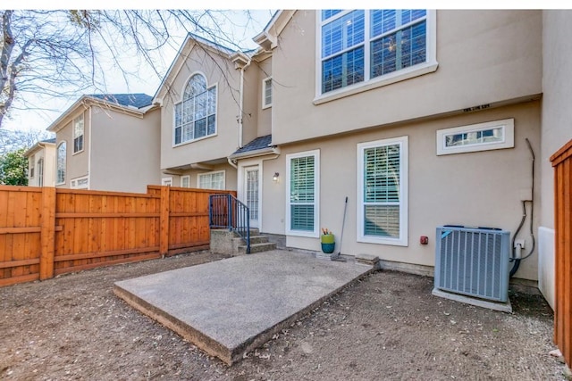 rear view of house with a patio and cooling unit