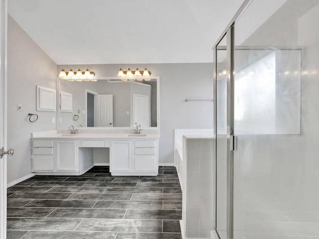 bathroom featuring vanity and independent shower and bath