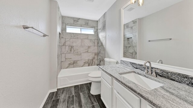 full bathroom featuring vanity, toilet, and tiled shower / bath