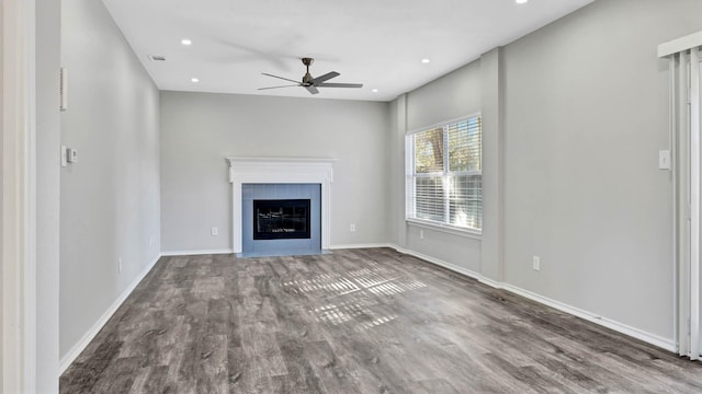 unfurnished living room with a fireplace, hardwood / wood-style floors, and ceiling fan