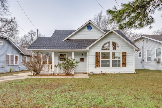 view of front of house with cooling unit, covered porch, and a front yard