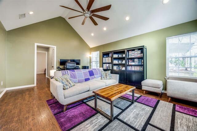 living room with dark hardwood / wood-style floors, high vaulted ceiling, and ceiling fan