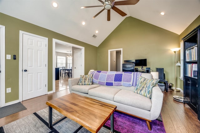 living room featuring ceiling fan, high vaulted ceiling, and hardwood / wood-style flooring