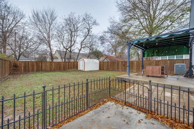 view of yard with a shed, central AC unit, and a patio area