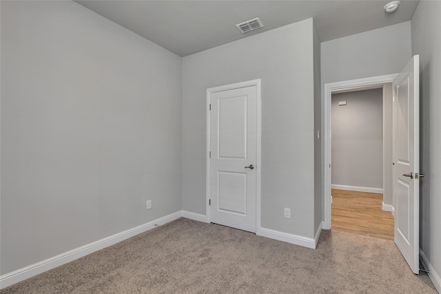 unfurnished bedroom featuring light colored carpet