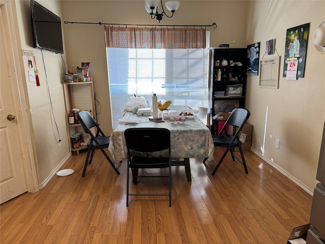 dining area featuring a chandelier and wood-type flooring