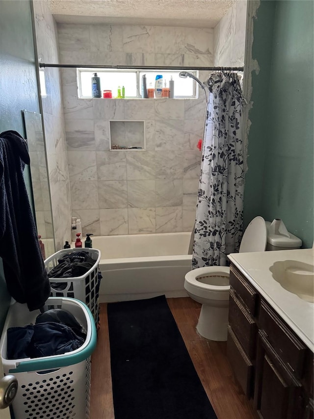 full bathroom with hardwood / wood-style floors, vanity, toilet, and shower / bathtub combination with curtain