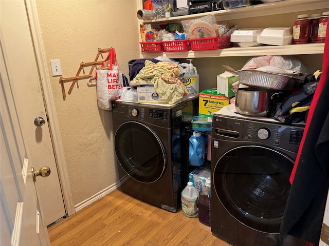 laundry area featuring light wood-type flooring and washer / clothes dryer