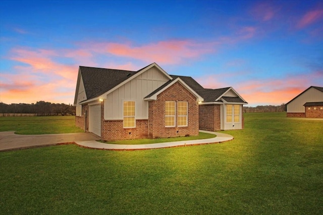 view of front of house with a garage and a lawn