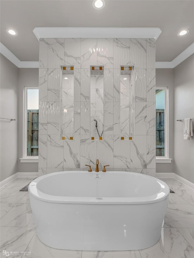 bathroom featuring ornamental molding and a bathtub