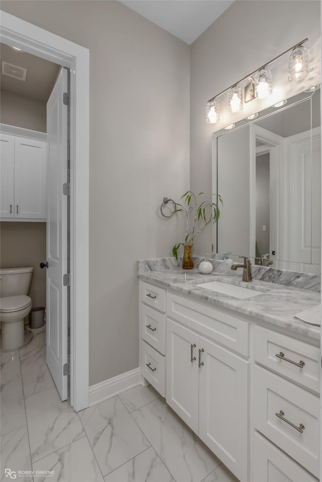 bathroom with vanity and toilet