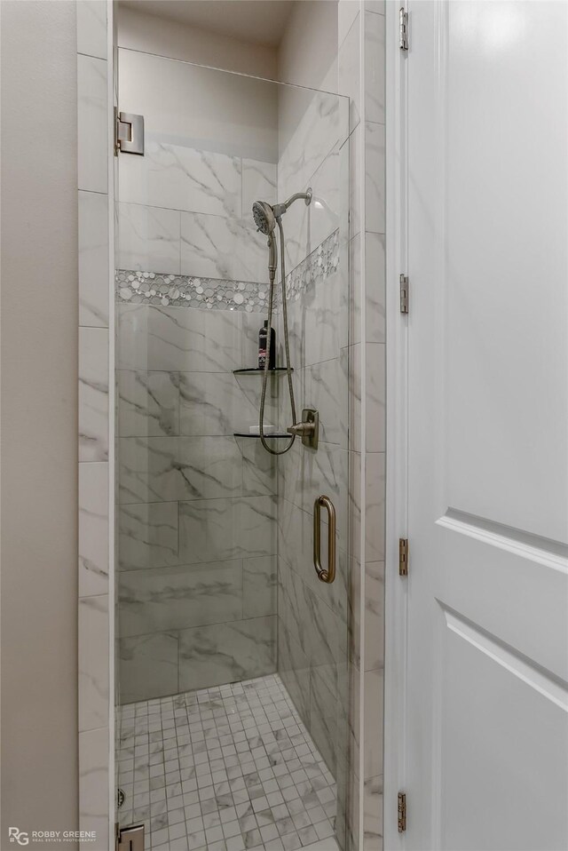 bathroom with a shower with shower door