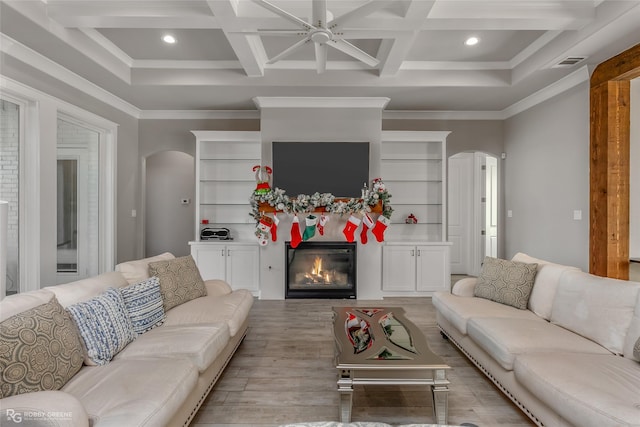 living room with beamed ceiling, crown molding, coffered ceiling, and light wood-type flooring