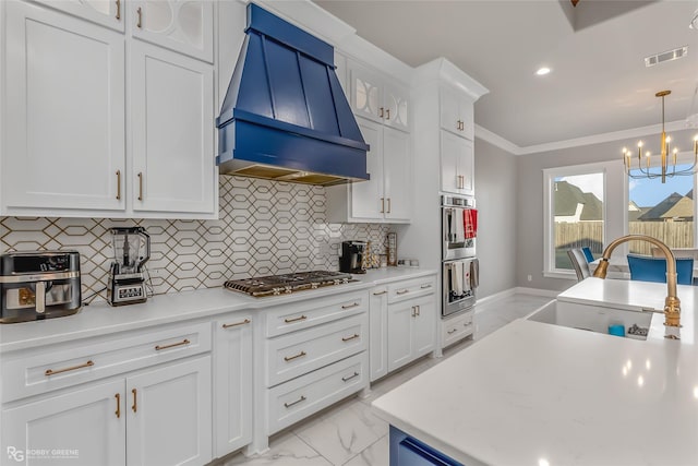 kitchen featuring white cabinetry, stainless steel appliances, sink, and custom exhaust hood