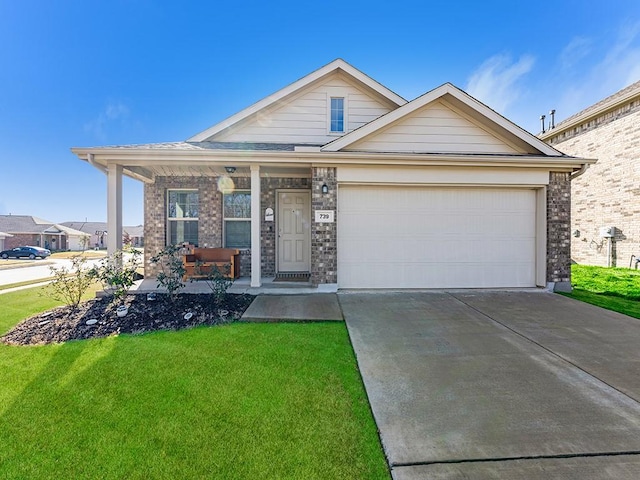 view of front of property featuring a porch, a garage, and a front lawn