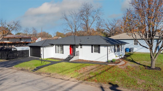 single story home with a garage and a front lawn