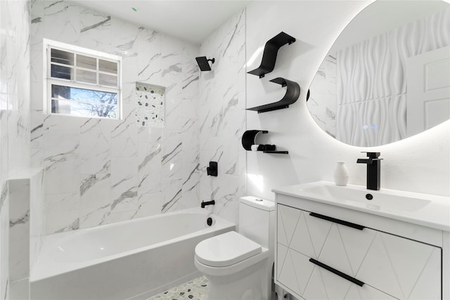 full bathroom featuring vanity, tiled shower / bath combo, and toilet