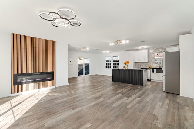 unfurnished living room featuring light hardwood / wood-style flooring