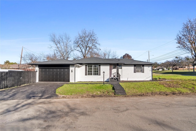 single story home featuring a garage and a front yard