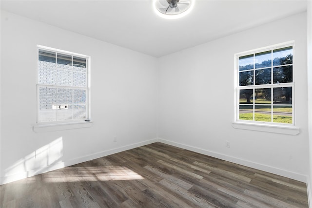 spare room with ceiling fan and dark wood-type flooring