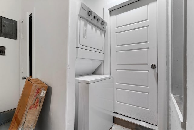 clothes washing area with stacked washer and dryer