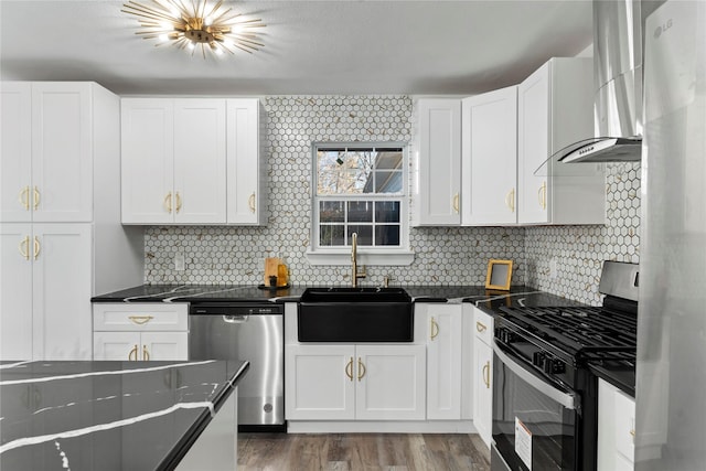 kitchen with white cabinets, stainless steel appliances, wall chimney exhaust hood, and sink