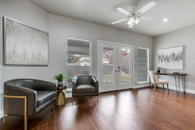 living area featuring french doors, ceiling fan, plenty of natural light, and dark hardwood / wood-style floors