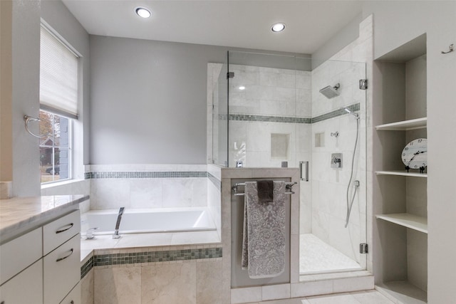 bathroom featuring vanity and separate shower and tub