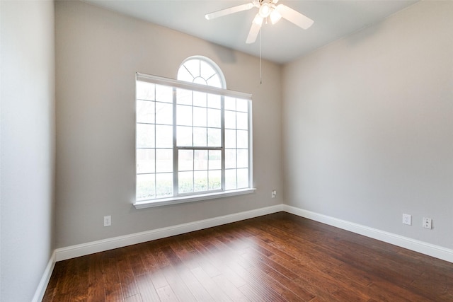 spare room with dark wood-type flooring and ceiling fan