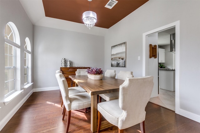 dining space featuring an inviting chandelier and dark hardwood / wood-style floors