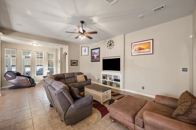 tiled living room with ceiling fan