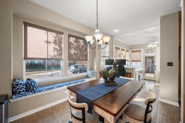 tiled dining area featuring ceiling fan with notable chandelier